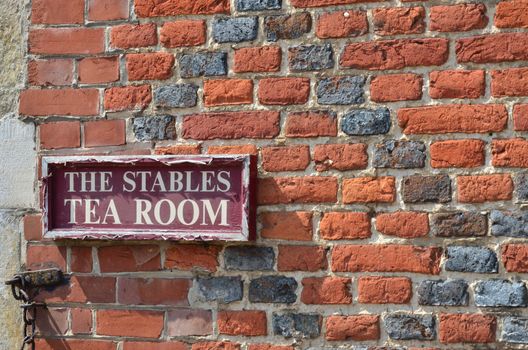 Tea room sign on brick