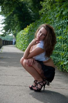 beautiful woman dancing in a short skirt on the waterfront