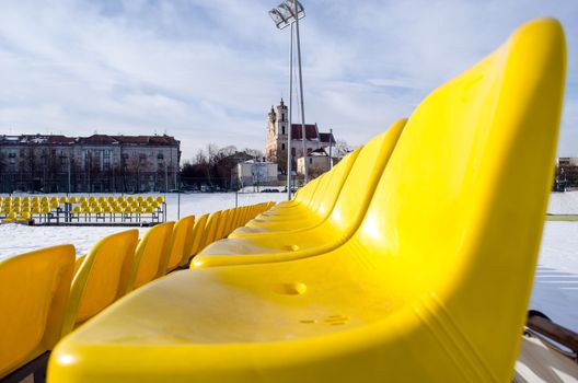yellow plastic chairs row of the volleyball court in the winter