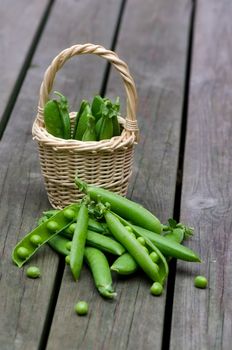 Fresh peas on a background of old boards