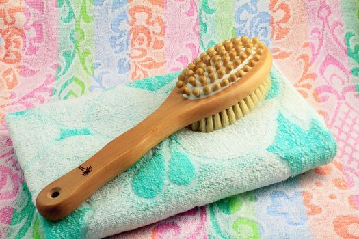 Wooden light brown brush with the long handle for body massage. Has wooden balls for massage and a rigid bristle for skin massage. Terry towel with an ornament.


