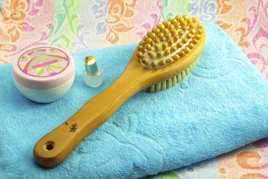 Wooden light-brown brush with a long handle to massage the body. Has a wooden balls for the massage and stubble for massage of the skin. Terry towel with ornaments and objects body care