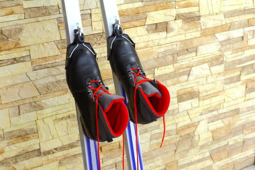 Black ski boots with red laces, installed in the mounting skiing