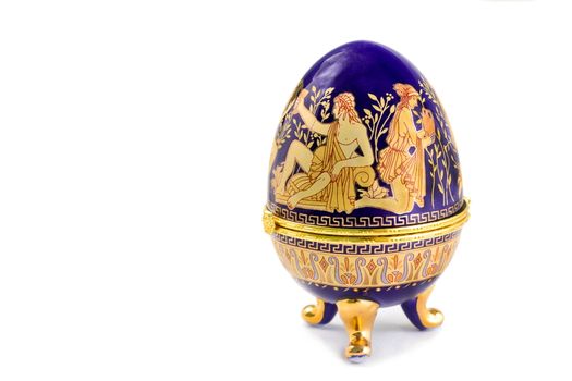 Casket of blue color with a gold list. It is executed in the form of an Easter egg, it is painted with scenes from antique life