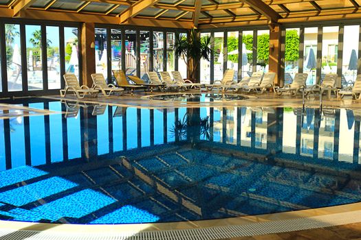 Indoor pool with comfortable glazed walls of the resort