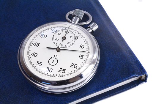 Shiny metal stopwatch and notebook blue. Presented on a white background.