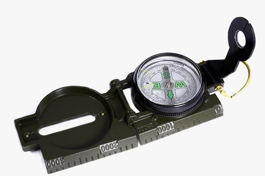 A small compass folding in a frame of metal. Presented on a white background
