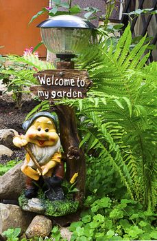 A lamp with the figure of fun smiling dwarf , ������������������ land and inviting into your garden.