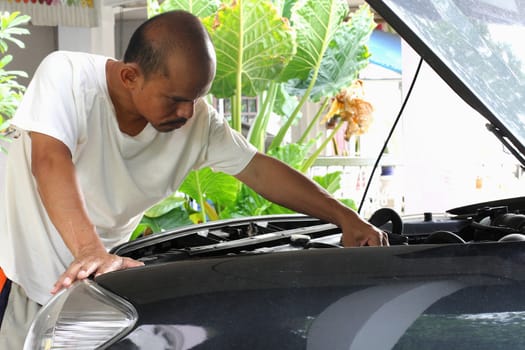 People are repairing cars.