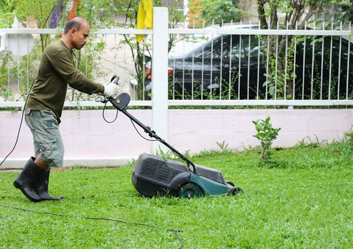 Man cutting grass. With the mower.