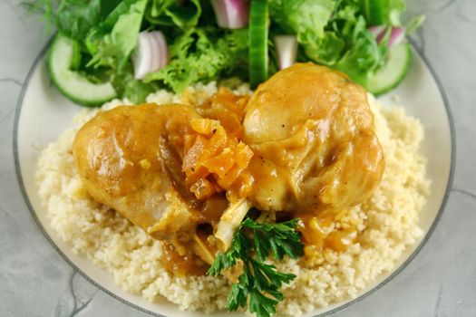 Apricot chicken drumsticks with a green side salad.