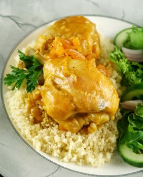 Apricot chicken drumsticks with a green side salad.