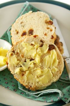 Fresh baked buttered raisin scones ready to eat.