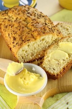 Delicious buttered slice of fresh caraway seed loaf ready to serve.