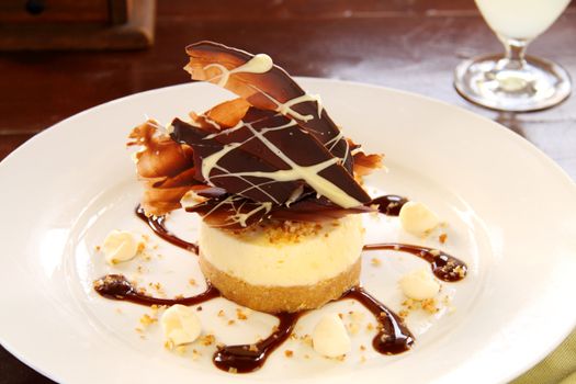 Delicious cheese cake with dark and white chocolate ready to serve.