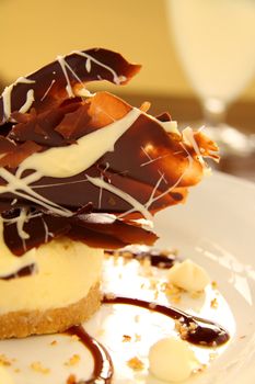 Delicious cheese cake with dark and white chocolate ready to serve.