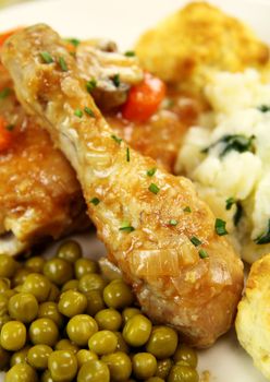 Baked chicken drumstick with peas and onion  gravy.