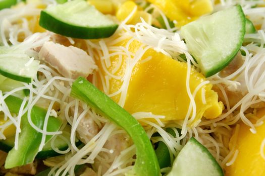 Delicious and colorful chicken, mango and noodle salad.