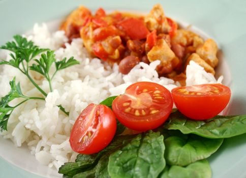 Spicy chicken lentil and pepper stew with rice and a fresh garden salad.