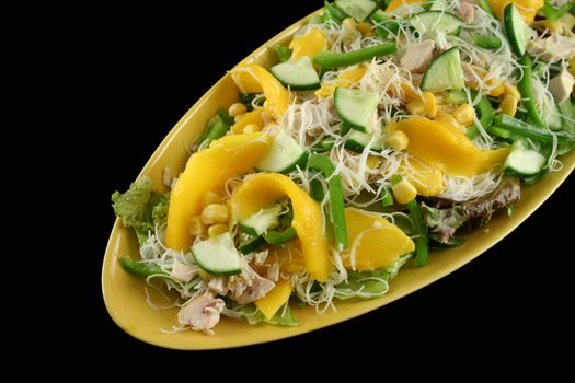 Delicious and colorful chicken, mango and noodle salad.