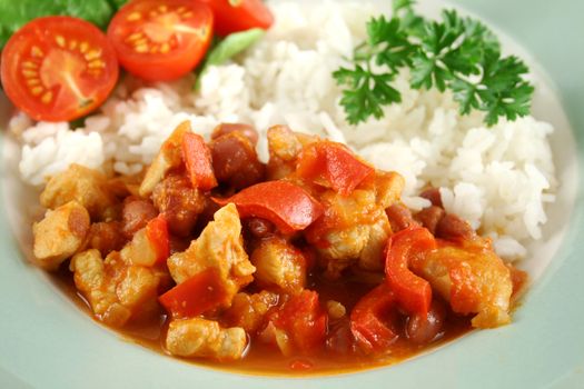 Spicy chicken lentil and pepper stew with rice and a fresh garden salad.