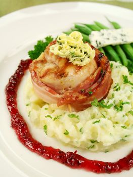 Chicken fillet mignon on parsley mashed potato with green beans and blue cheese and red wine and raspberry jus.