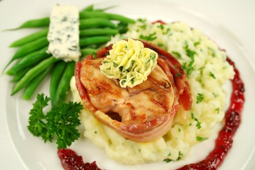 Chicken fillet mignon on parsley mashed potato with green beans and blue cheese.