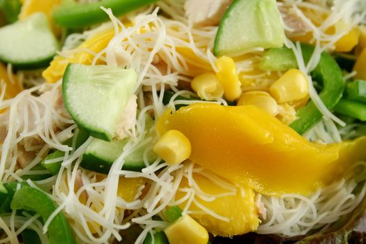 Delicious and colorful chicken, mango and noodle salad.