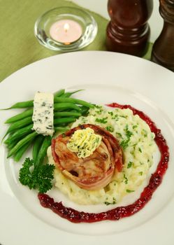 Chicken fillet mignon on parsley mashed potato with blue cheese and green beans.