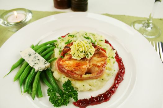 Chicken fillet mignon on parsley mashed potato with blue cheese and green beans.