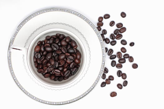 Coffee beans in a glass on a white background.