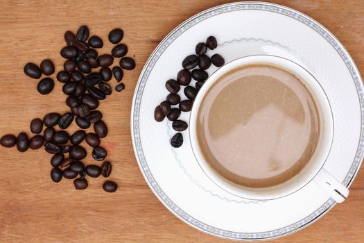 Coffee beans with coffee. wood background