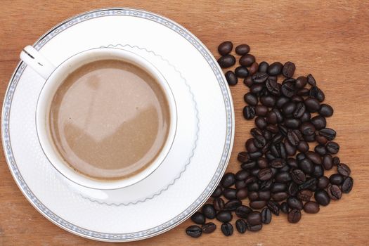 Coffee beans with coffee. wood background