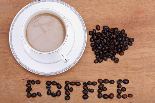 Coffee beans with coffee. wood background