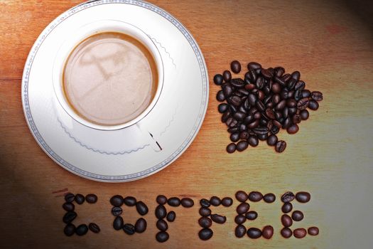 Coffee beans with coffee. wood background