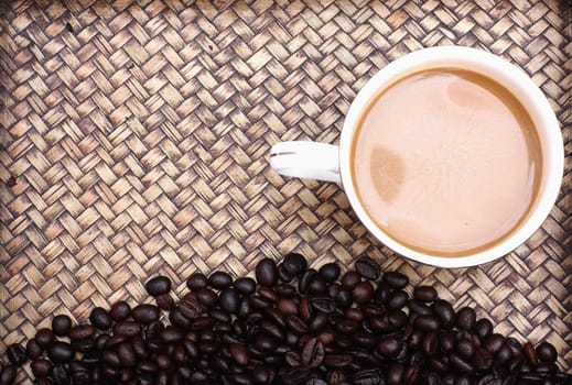 Coffee beans with coffee. Bamboo background