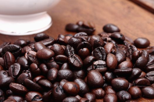 Coffee beans with coffee. wood background