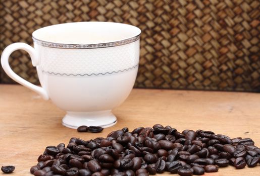 Coffee beans with coffee. wood background