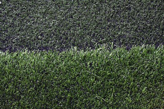 Grass football field with gravel.