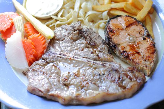 T-Bone steaks and salmon.