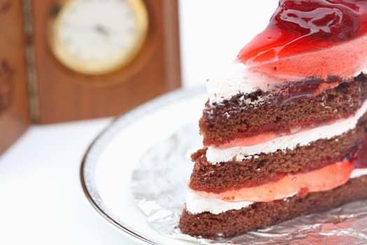 Strawberry cake on a white and clock background.