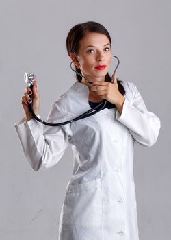 Woman doctor in a white coat with a stethoscope