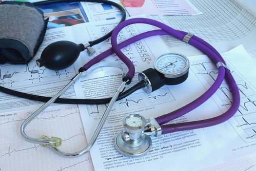 Against the background of the medical documentation are medical tools: a stethoscope for auscultation of patients and stethoscope blood pressure measurement.