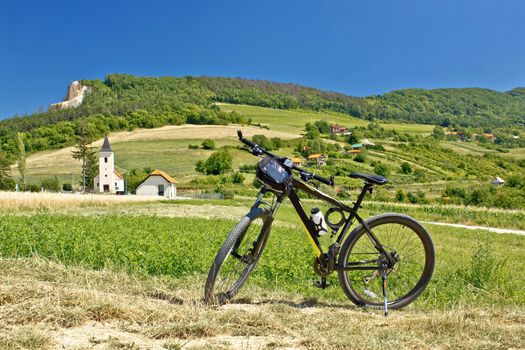 Mountain bike in green landscape, fields, nature