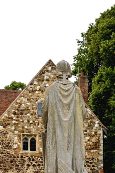 Religious statue with church background
