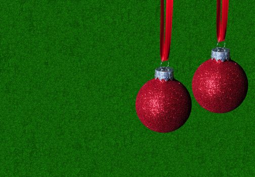 red glitter christmas ornaments on green background