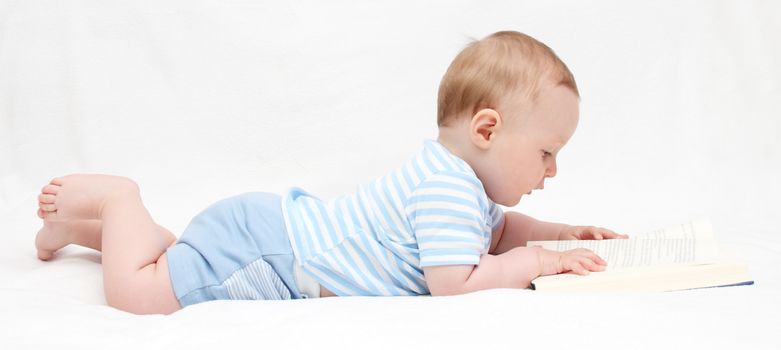 Baby boy reading a book