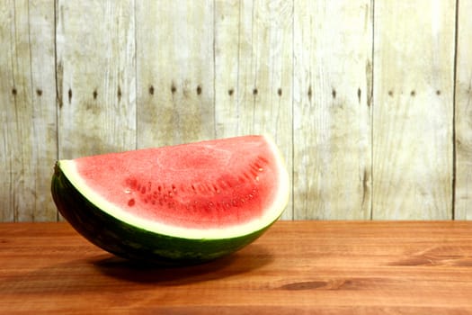 Watermelon Fruit Sliced Sitting on a Wooden Surface