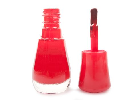 bottle of red nail polish and brush isolated on white background