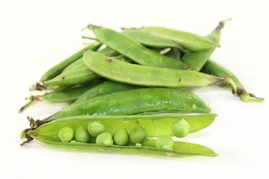 fresh green peas on a white background